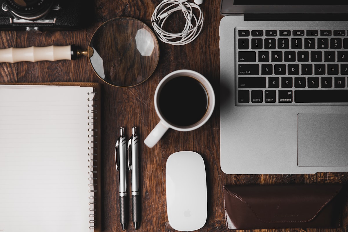 Laptop and coffee on desk in cafe setting